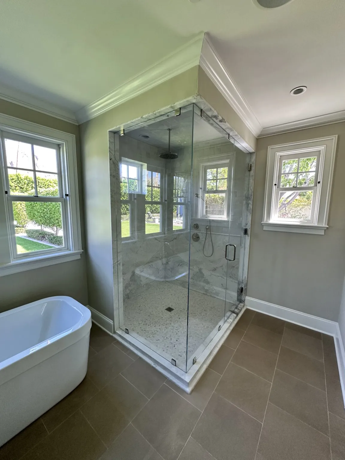 Luxury glass shower and marble tile bathroom installation